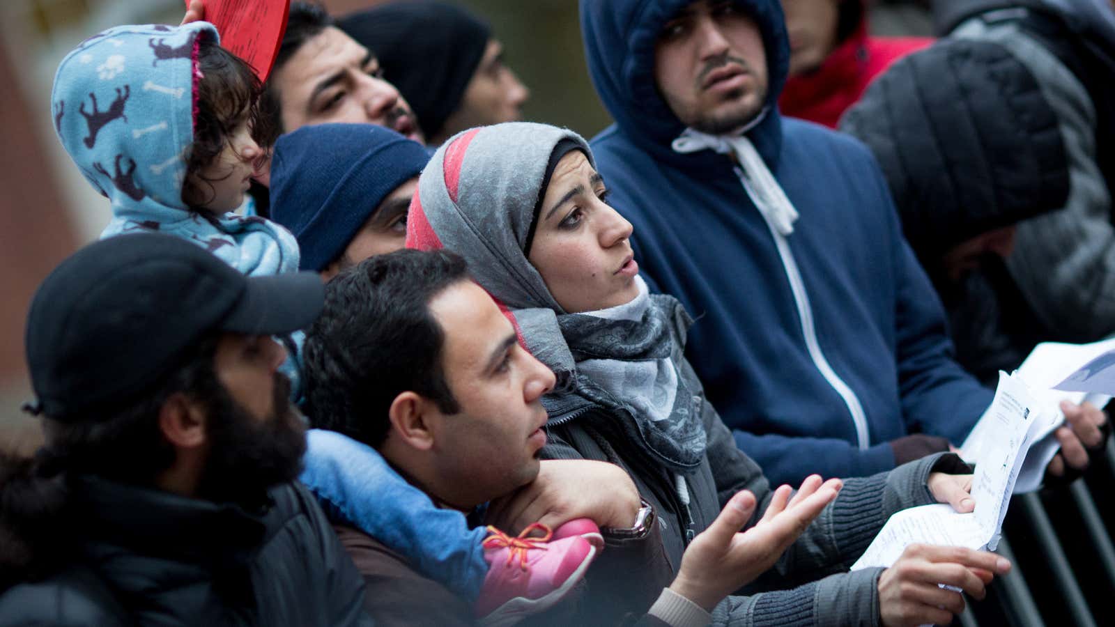 Refugees wait in line to register in Berlin in 2015