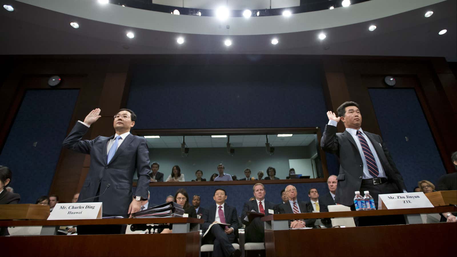Charles Ding, Huawei Technologies Ltd senior vice president for the US, left, and Zhu Jinyun, ZTE Corporation senior vice president for North America and Europe before the House Intelligence Committee on Sept. 13, 2012