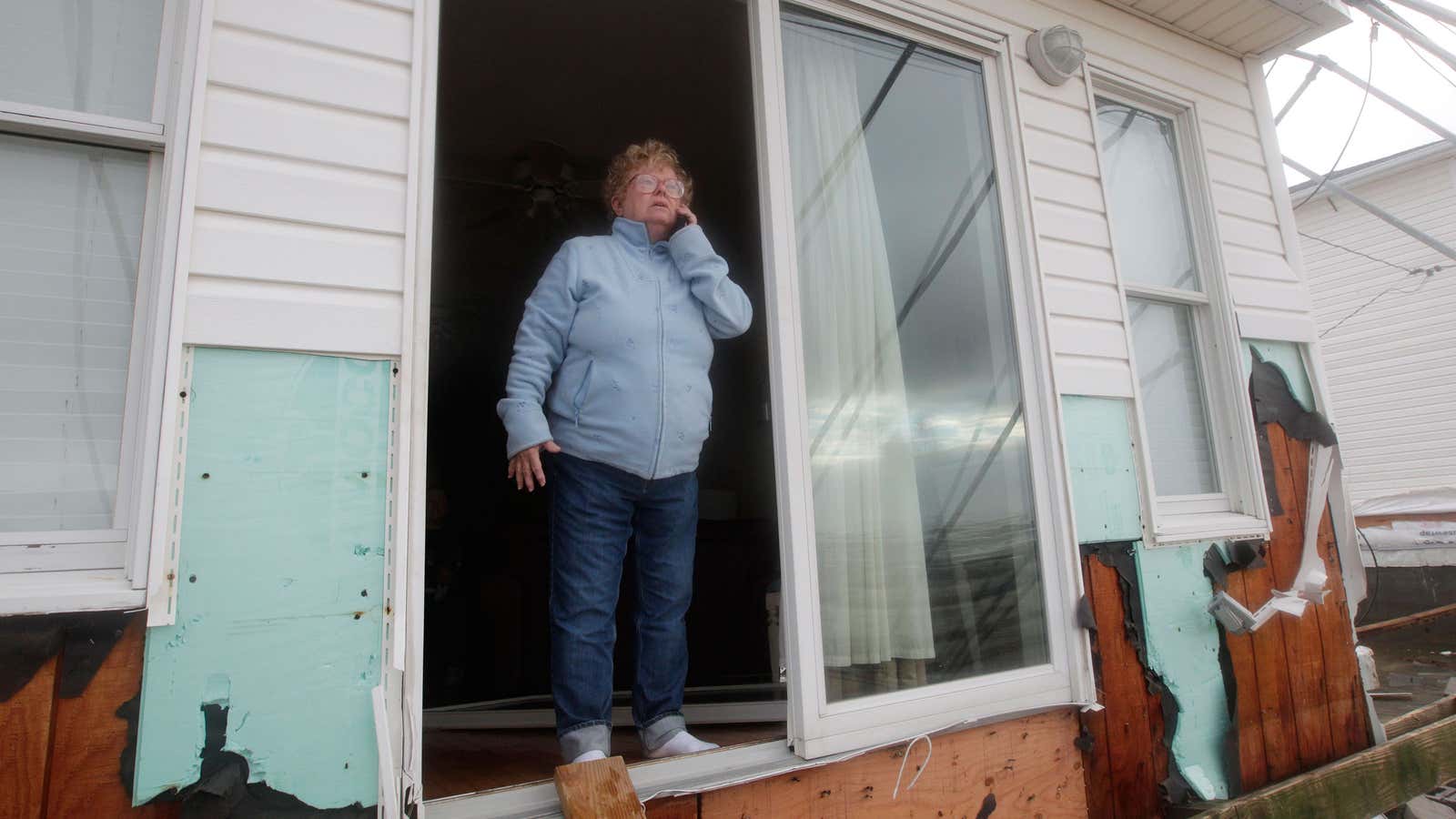 Kathy Jones calls her family after her home was damaged during Hurricane Sandy