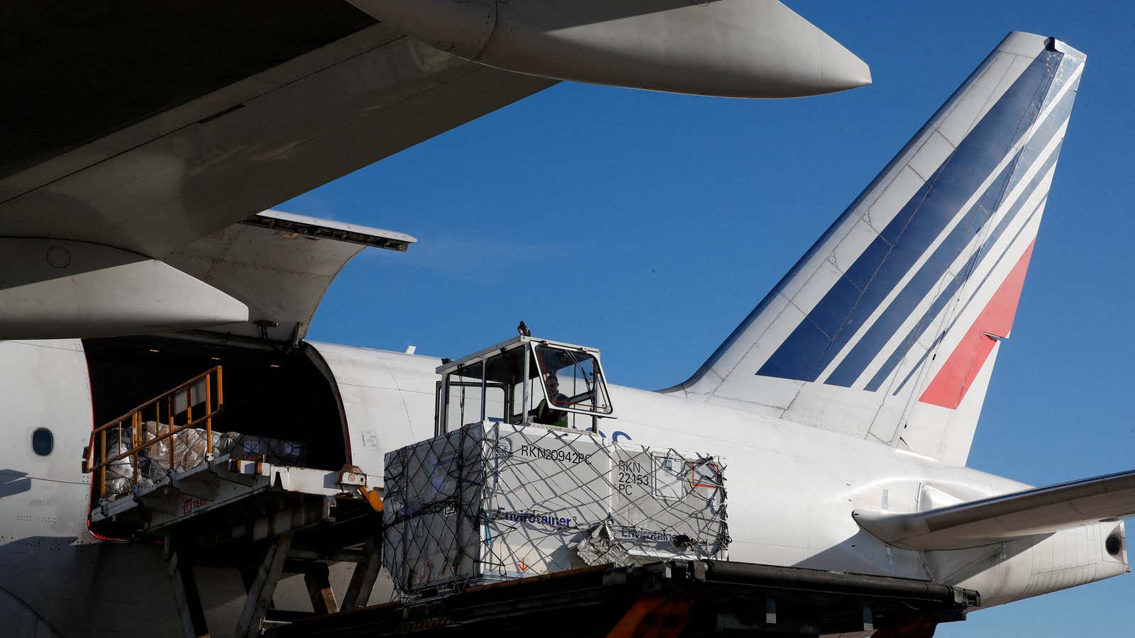 Air France employees load a Boeing 777 cargo plane at Charles de Gaulle airport.