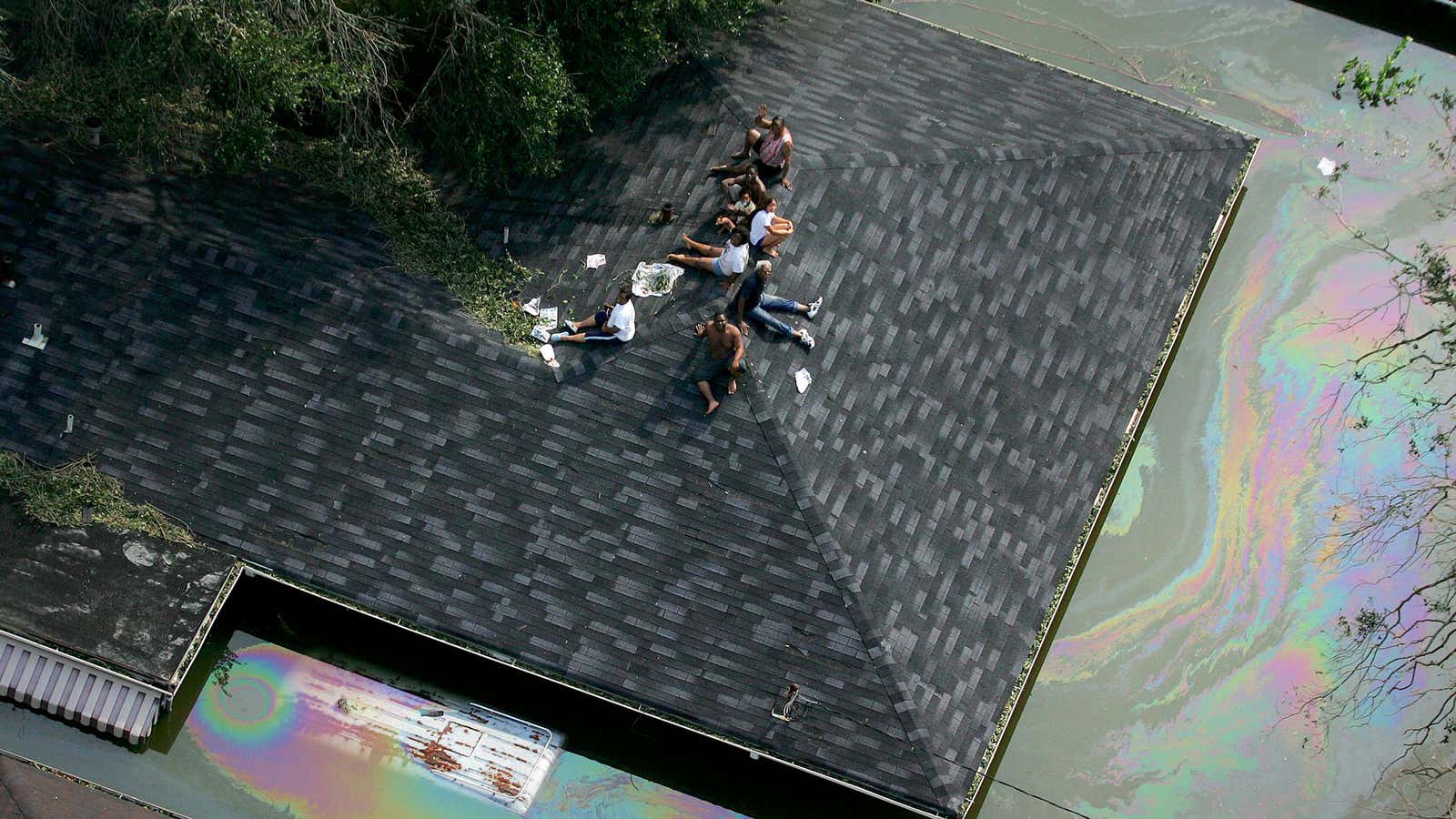 People stranded on a roof in New Orleans by Hurricane Katrina&#39;s floodwaters 15 years ago today.
