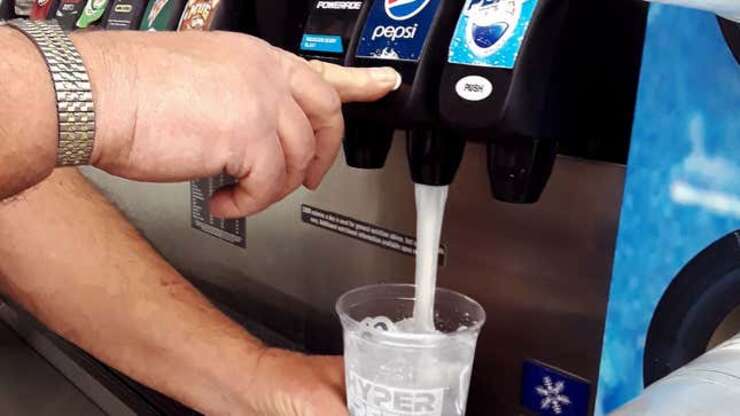 Image for Man Looks On Helplessly As Cascade Of Clear Liquid Fills Cup At Soda Fountain