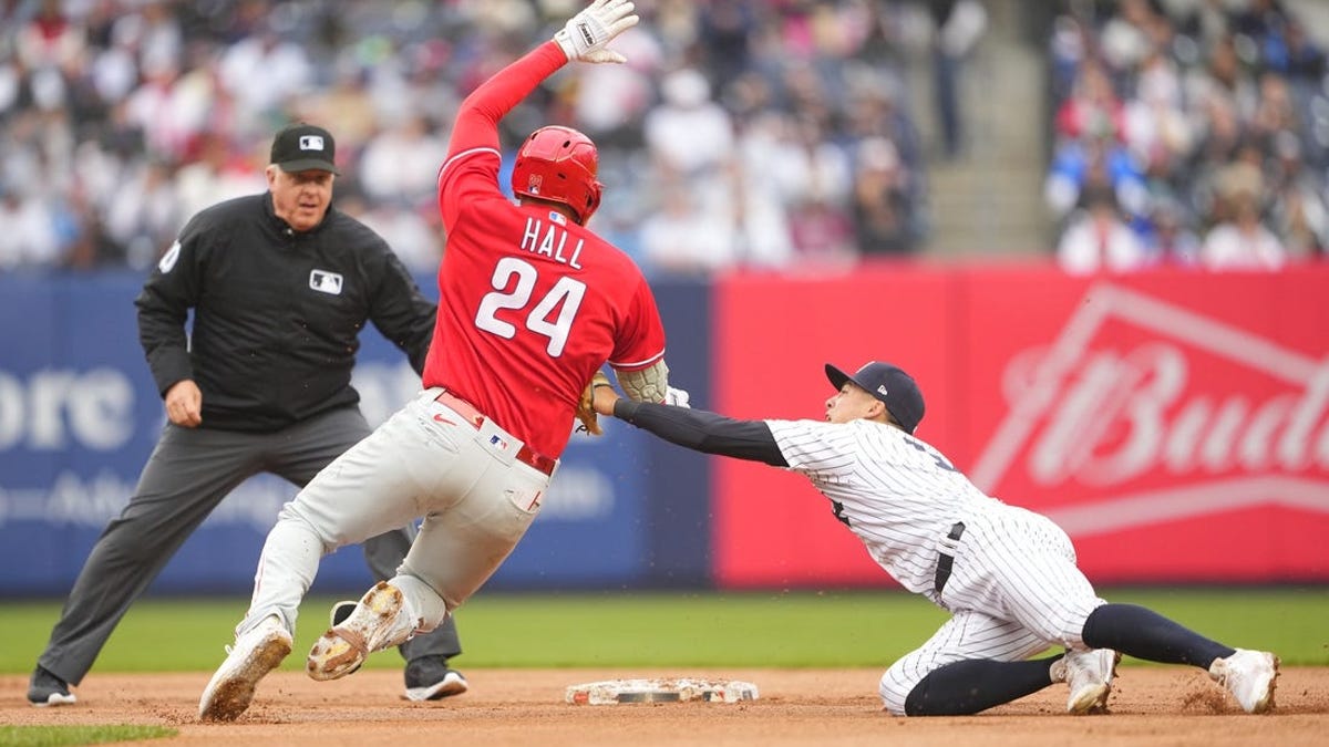 Philadelphia Phillies' Jake Cave hits an RBI sacrifice fly off New