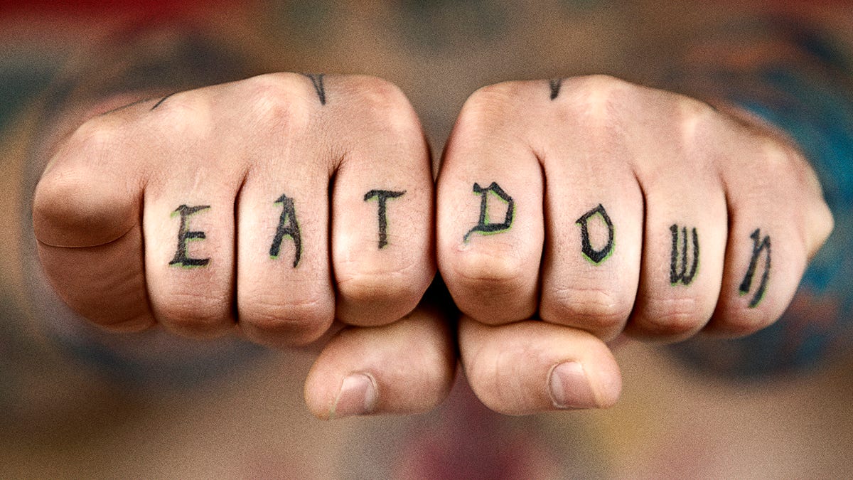 knuckle tattoos of the logos of Superman, Batman, Green