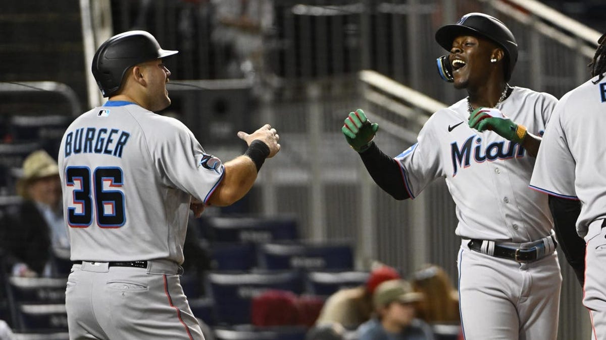 Miami Marlins' Jake Burger celebrates his home run during the