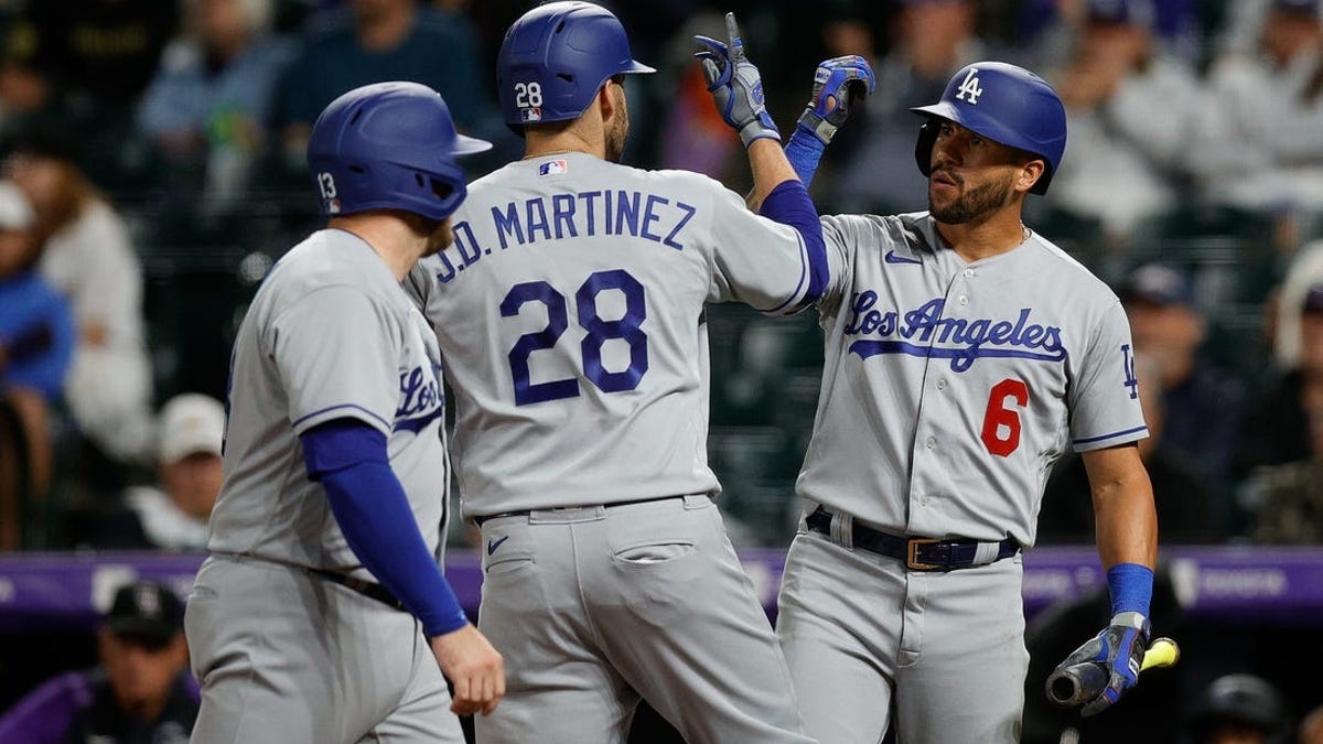 Martinez helps power Dodgers past Rockies 14-3 after severe weather delay