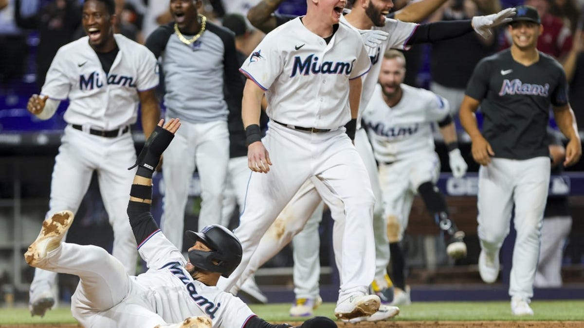 Miami Marlins' Yuli Gurriel celebrates the last out of the third