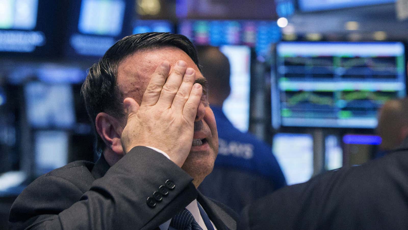 An NYSE official gestures on the floor of the New York Stock Exchange, July 8, 2015.