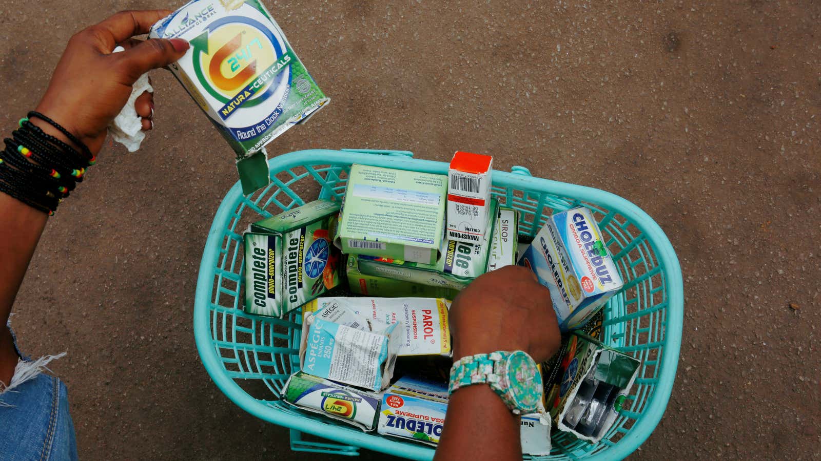 A woman holds illegal and fake drugs in Abidjan, Ivory Coast