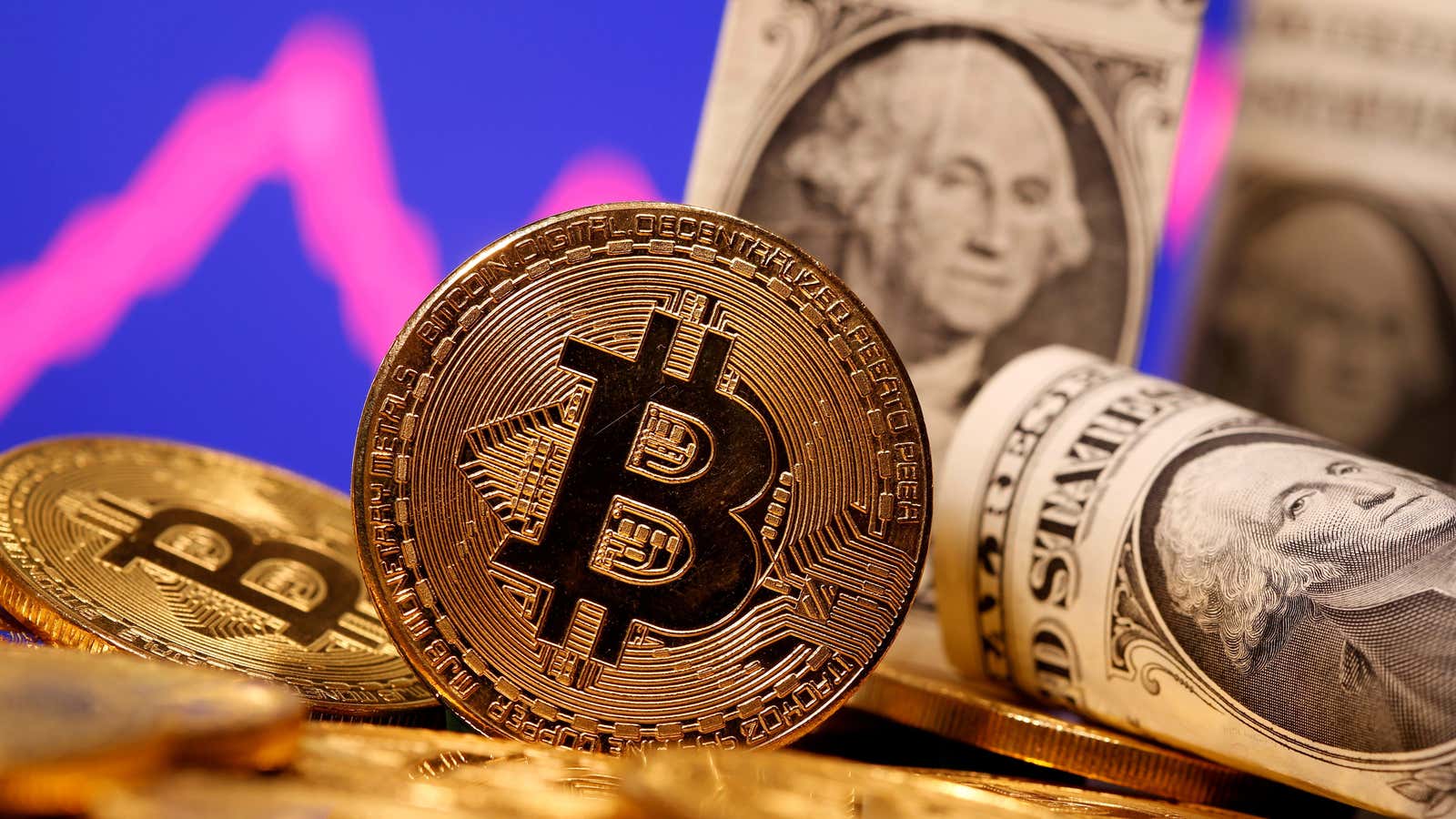 FILE PHOTO: A representation of virtual currency Bitcoin and U.S. One Dollar banknotes are seen in front of a stock graph in this illustration taken…