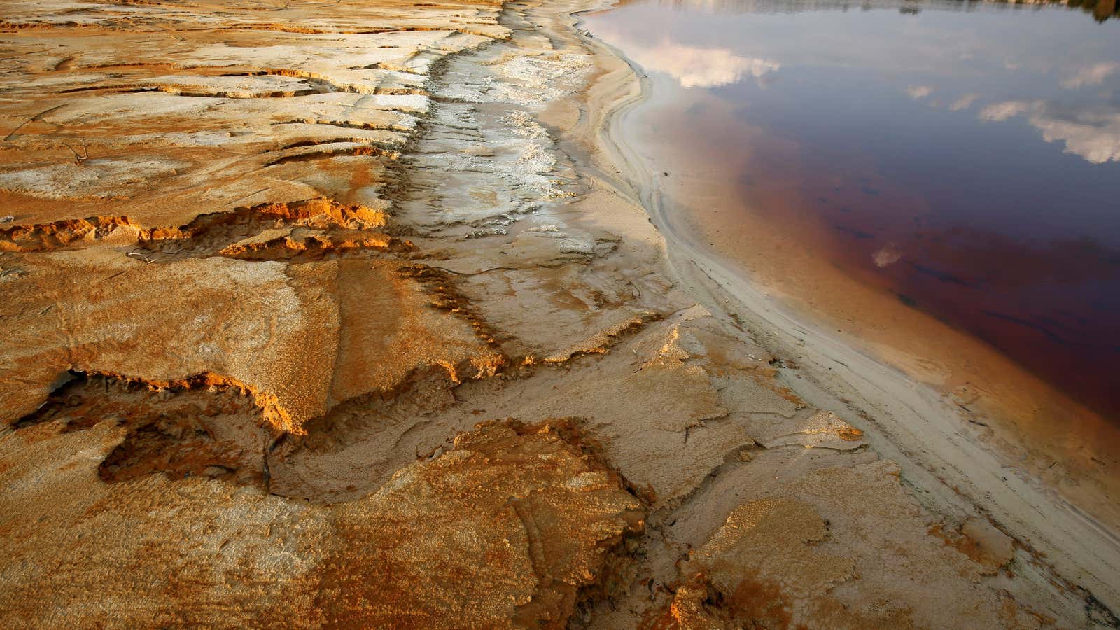 Polluted water emanating from mining operations fills a dam near Johannesburg, South Africa, Sept. 24, 2015.