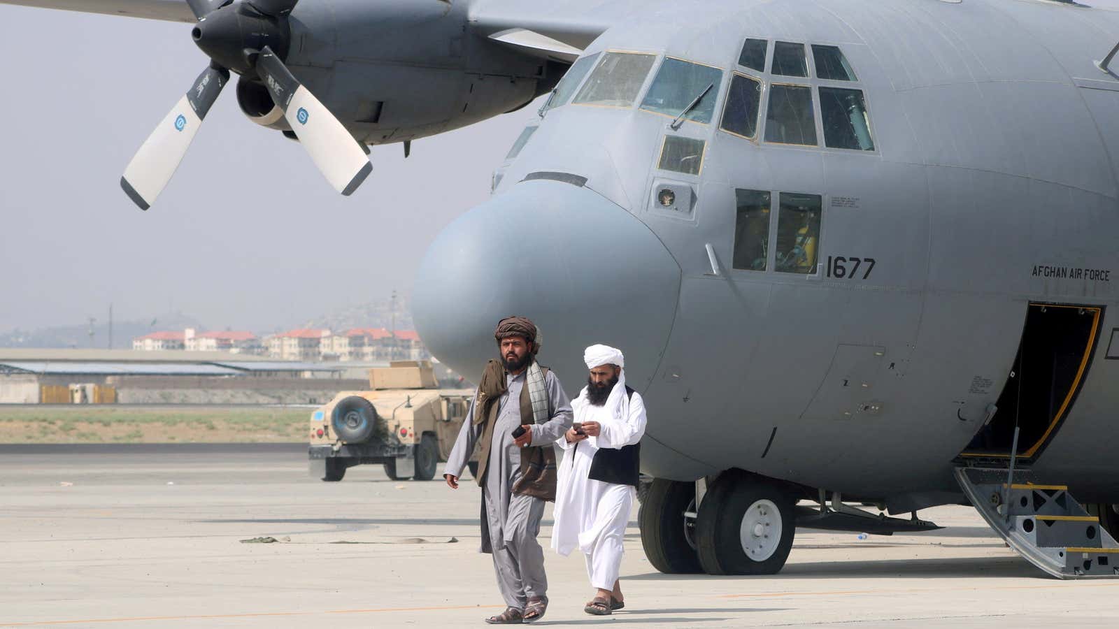 Taliban walk in front of a military airplane a day after the US troops withdrew from Hamid Karzai International Airport in Kabul, Afghanistan August 31.