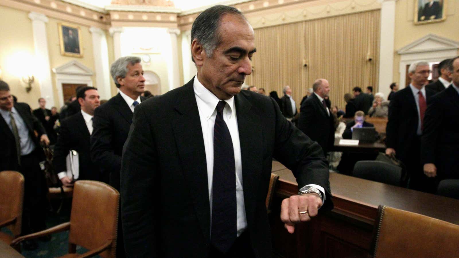 John Mack, then-chairman of Morgan Stanley, checks his watch after testifying to the Financial Crisis Inquiry Commission.