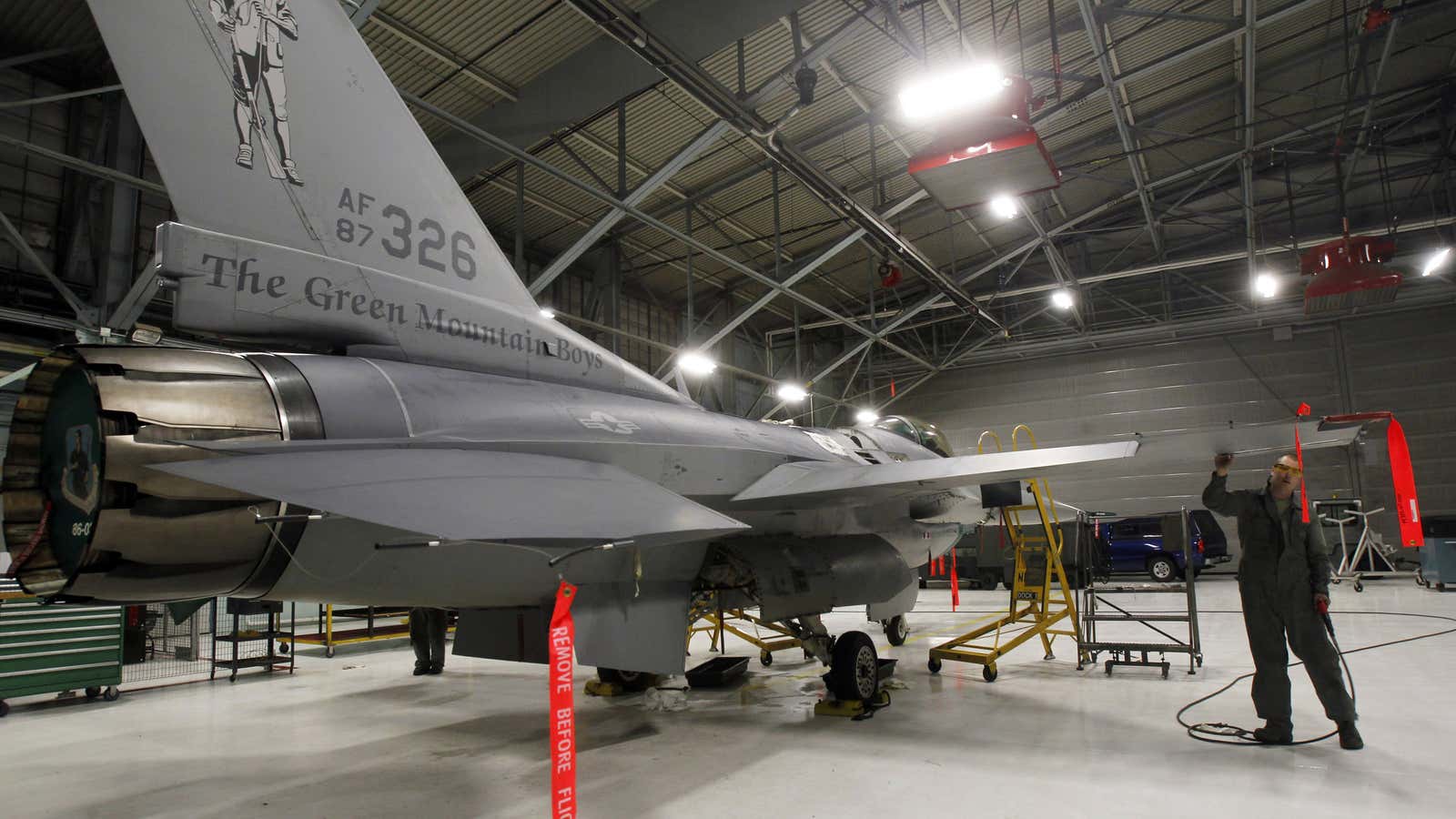 FILE – In this Monday, Dec. 17, 2012 photo, Master Sgt. Andrew Ehlers does repairs on an F-16 fighter plane in South Burlington, Vt. The…