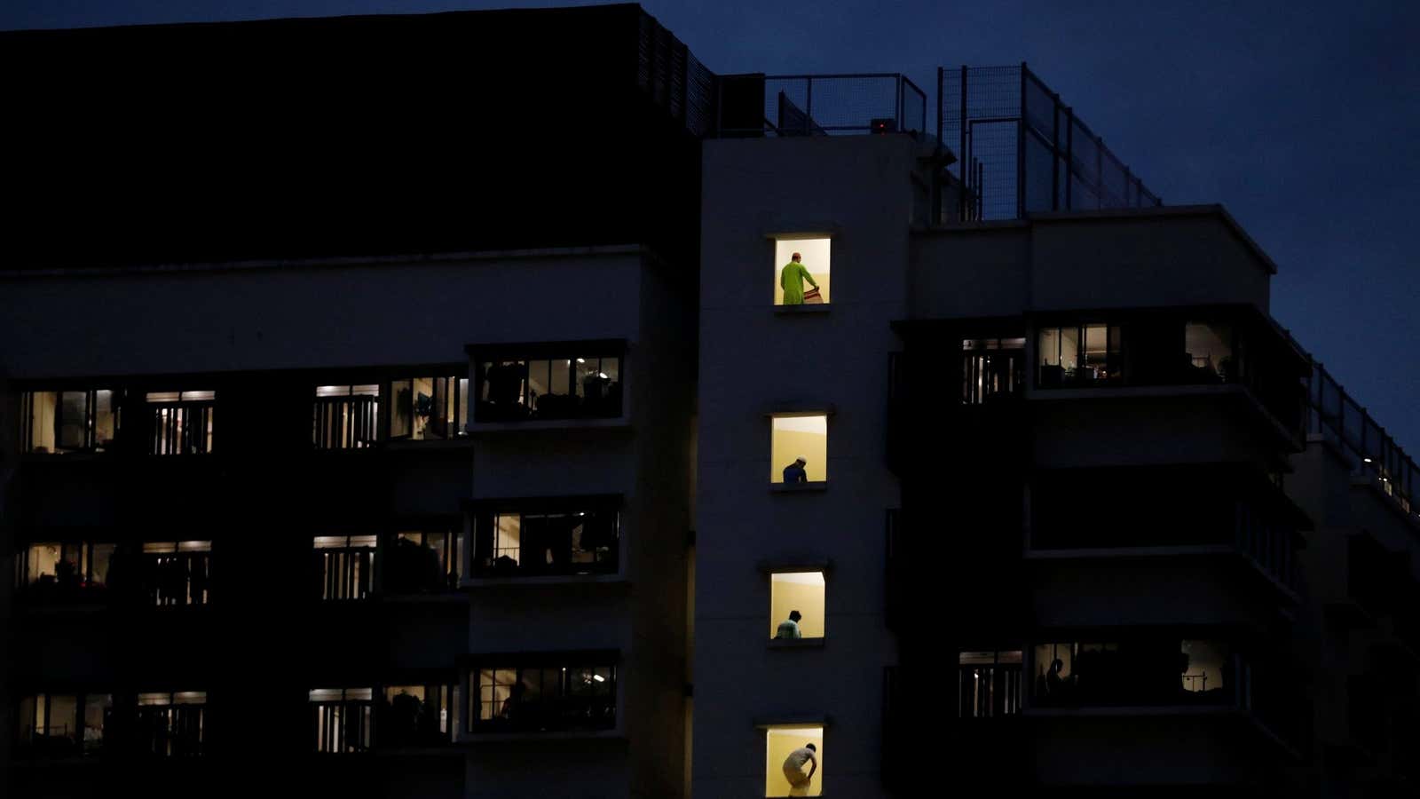 Migrant workers pray in their dormitory during the holy month of Ramadan, amid the coronavirus disease (COVID-19) outbreak, in Singapore May 10, 2020. Picture taken…