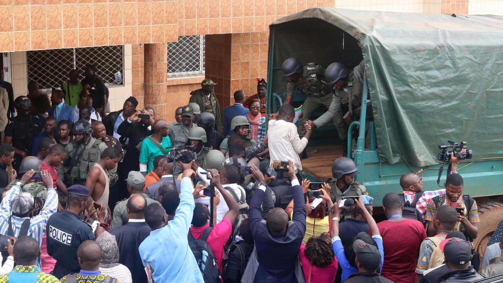 School children, who were kidnapped by armed men and released on Wednesday, are helped to get into a truck by gendarmes in Bamenda, Cameroon, Nov. 7.