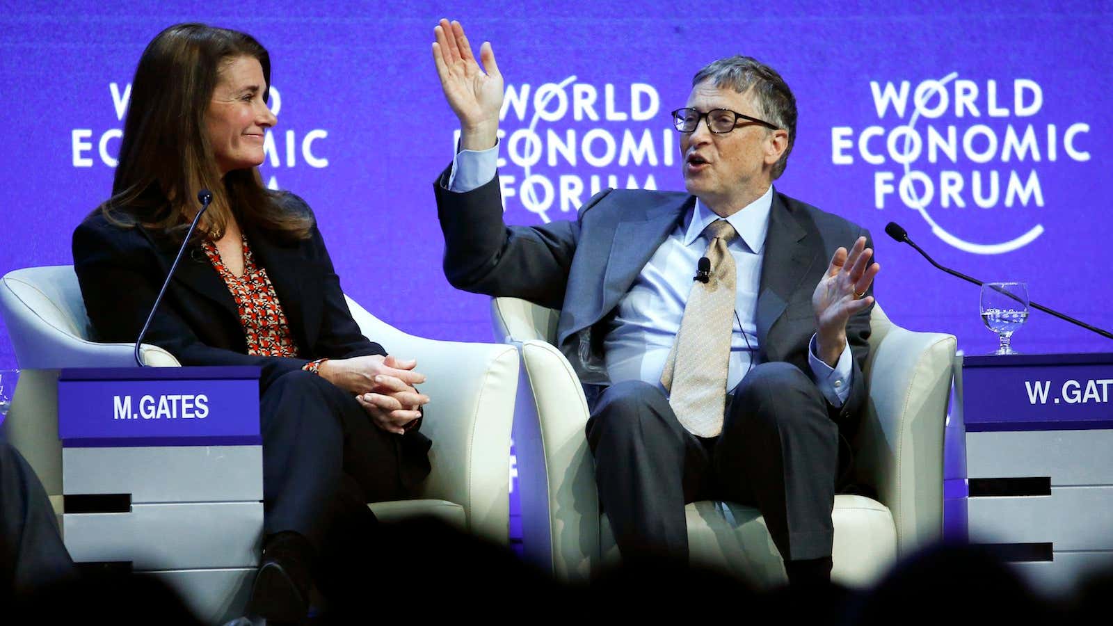 Bill Gates, Co-Chair of the Bill and Melinda Gates Foundation gestures next to his wife Melinda French Gates.