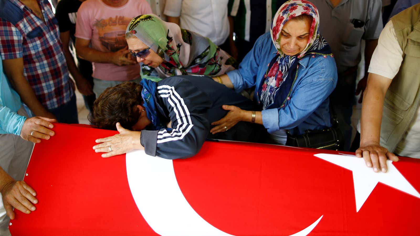 Relatives of a victim of Tuesday’s attack mourn at her funeral.