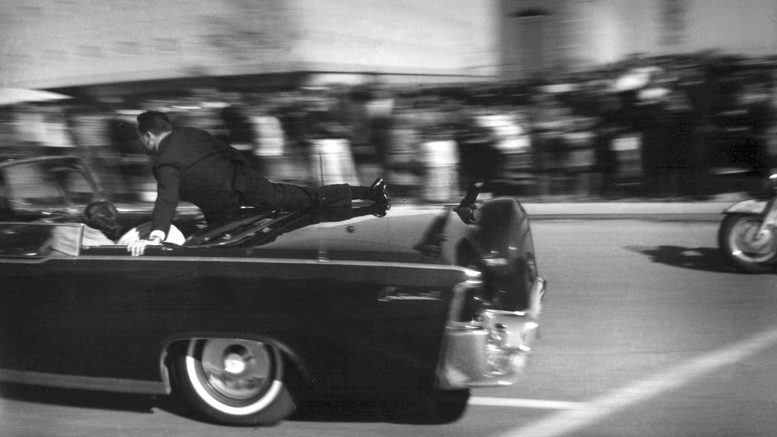 The limousine carrying mortally wounded President John F. Kennedy races toward the hospital seconds after he was shot in Dallas.