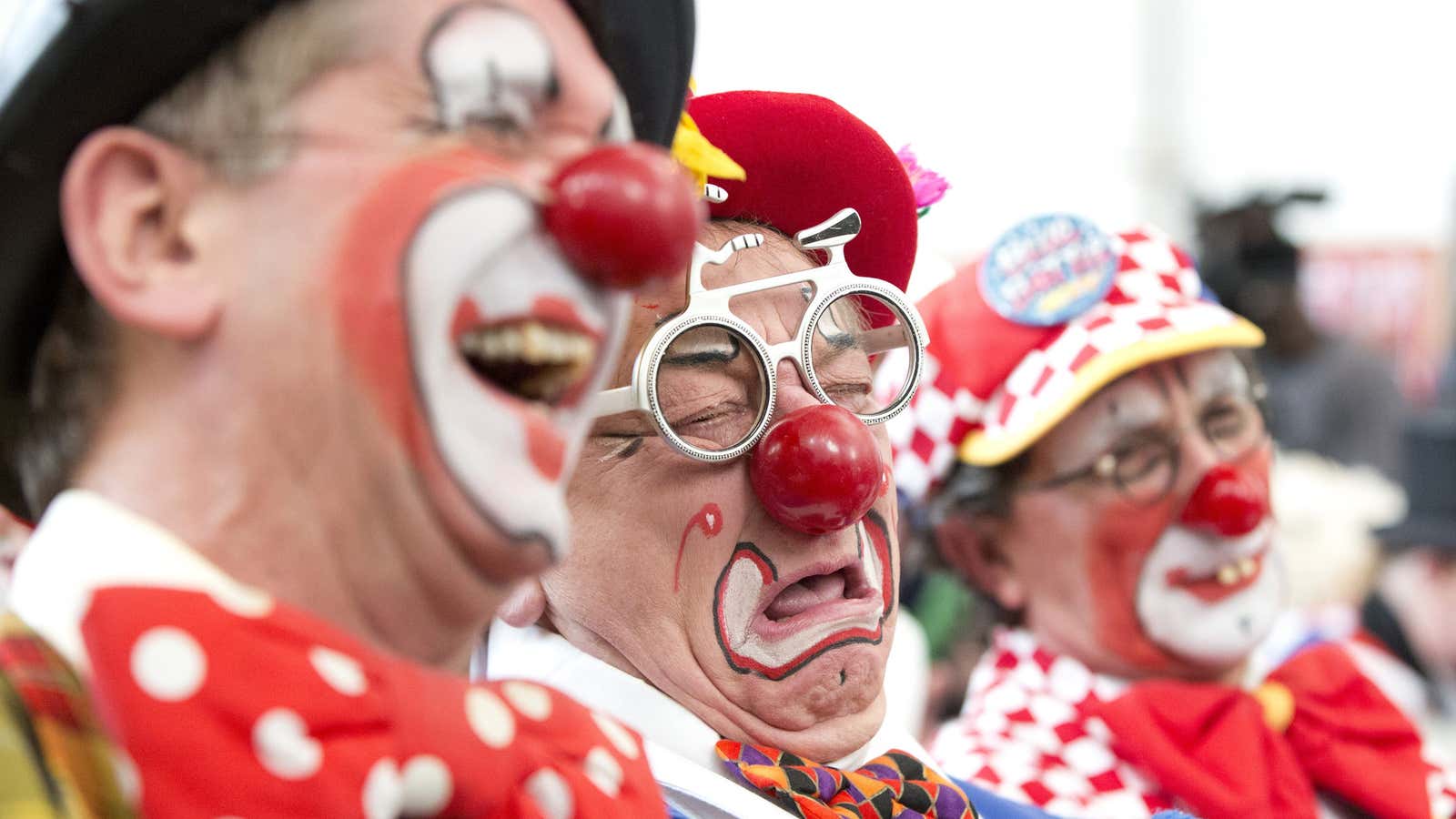 Clowns react during a church service in memory of Joseph Grimaldi at Holy Trinity Church in Dalston, east London February 2, 2014. The church holds an annual February clown service in memory of Britain’s best loved clown, Joseph Grimaldi, who lived from 1778 to 1837. REUTERS/Neil Hall (BRITAIN – Tags: SOCIETY ANNIVERSARY) – GM1EA2301CS01