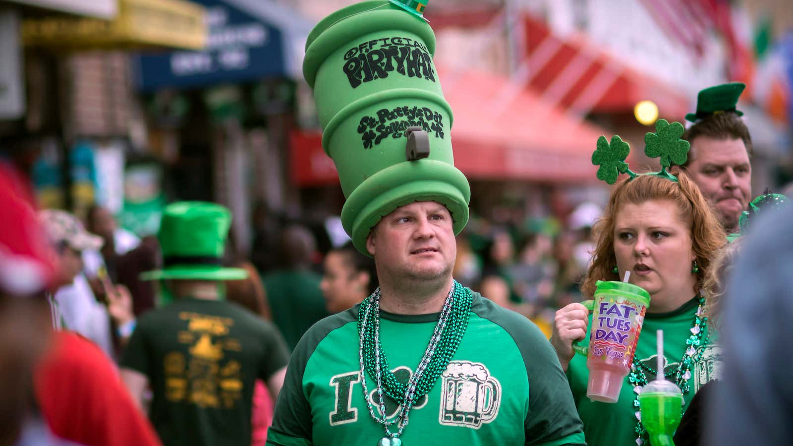 Dressed in a large foam beer keg hat Glenn Mikos of Covington, Ga. walks with his friends and family during the start of a four-day…