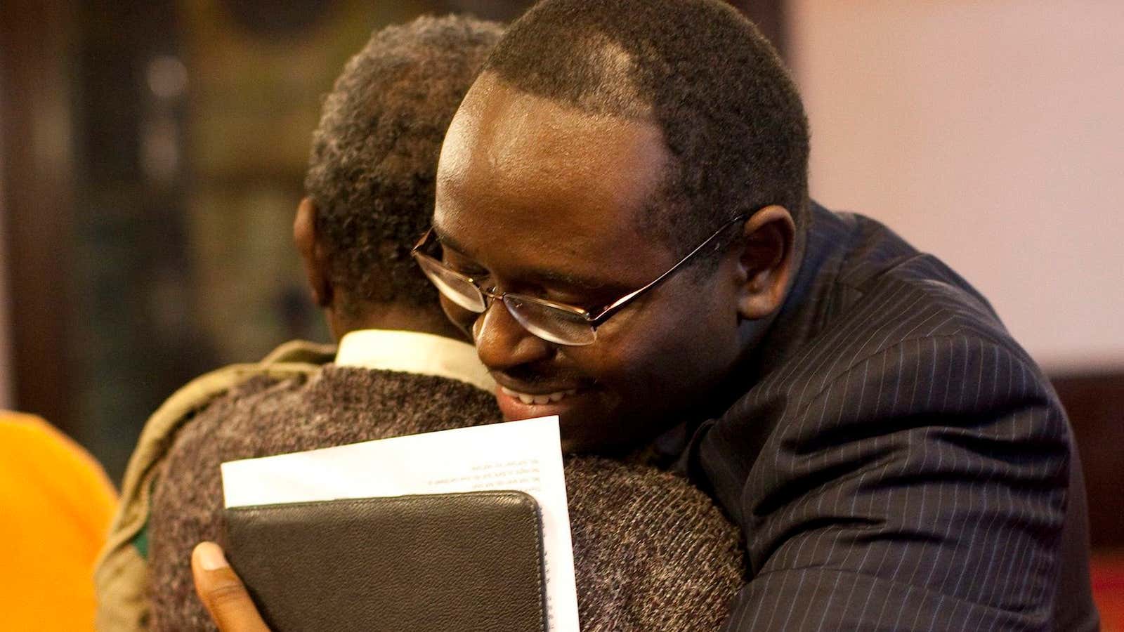 Rev. Clementa Pinckney of the Emanuel African Methodist Episcopal Church in Charleston, South Carolina hugging a church member in 2013.