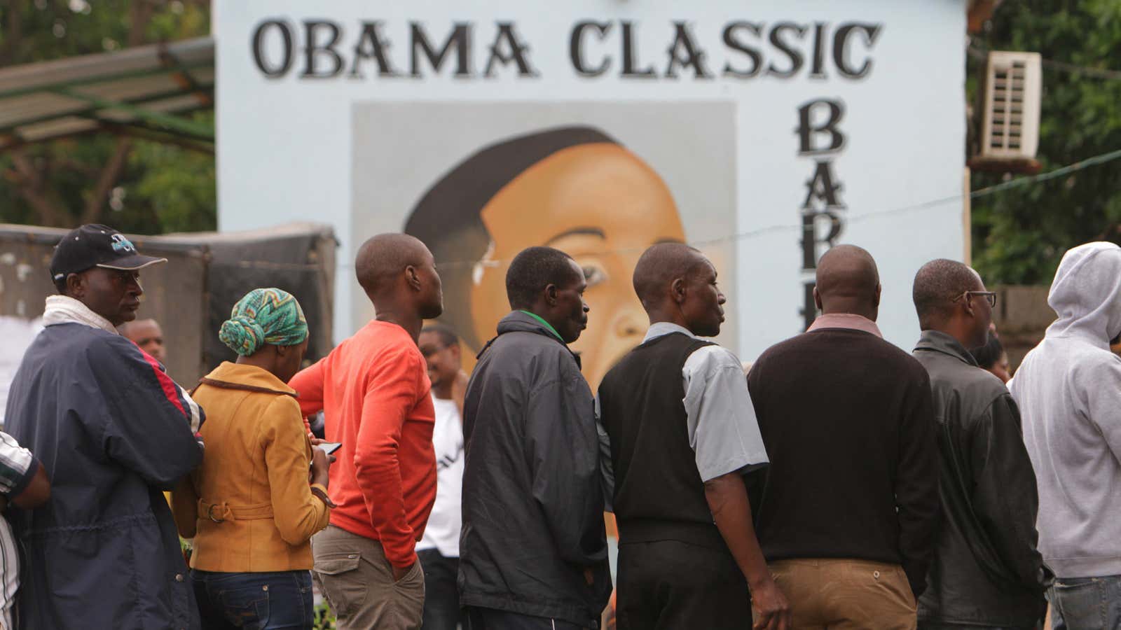 Zambians wait to vote outside a familiarly named barbershop