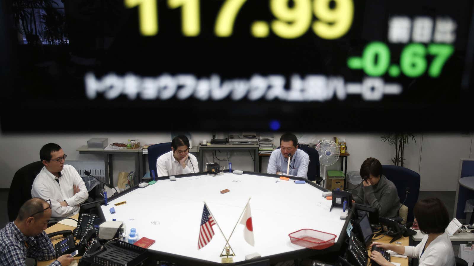 Employees of a foreign currency company work in a dealing room in Tokyo.