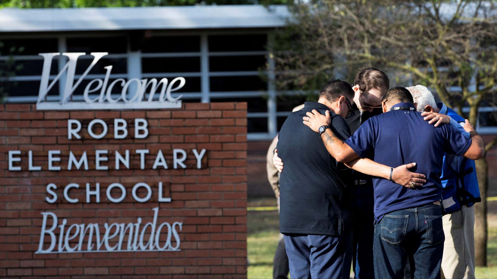 People gather at Robb Elementary School, the scene of a mass shooting in Uvalde, Texas.