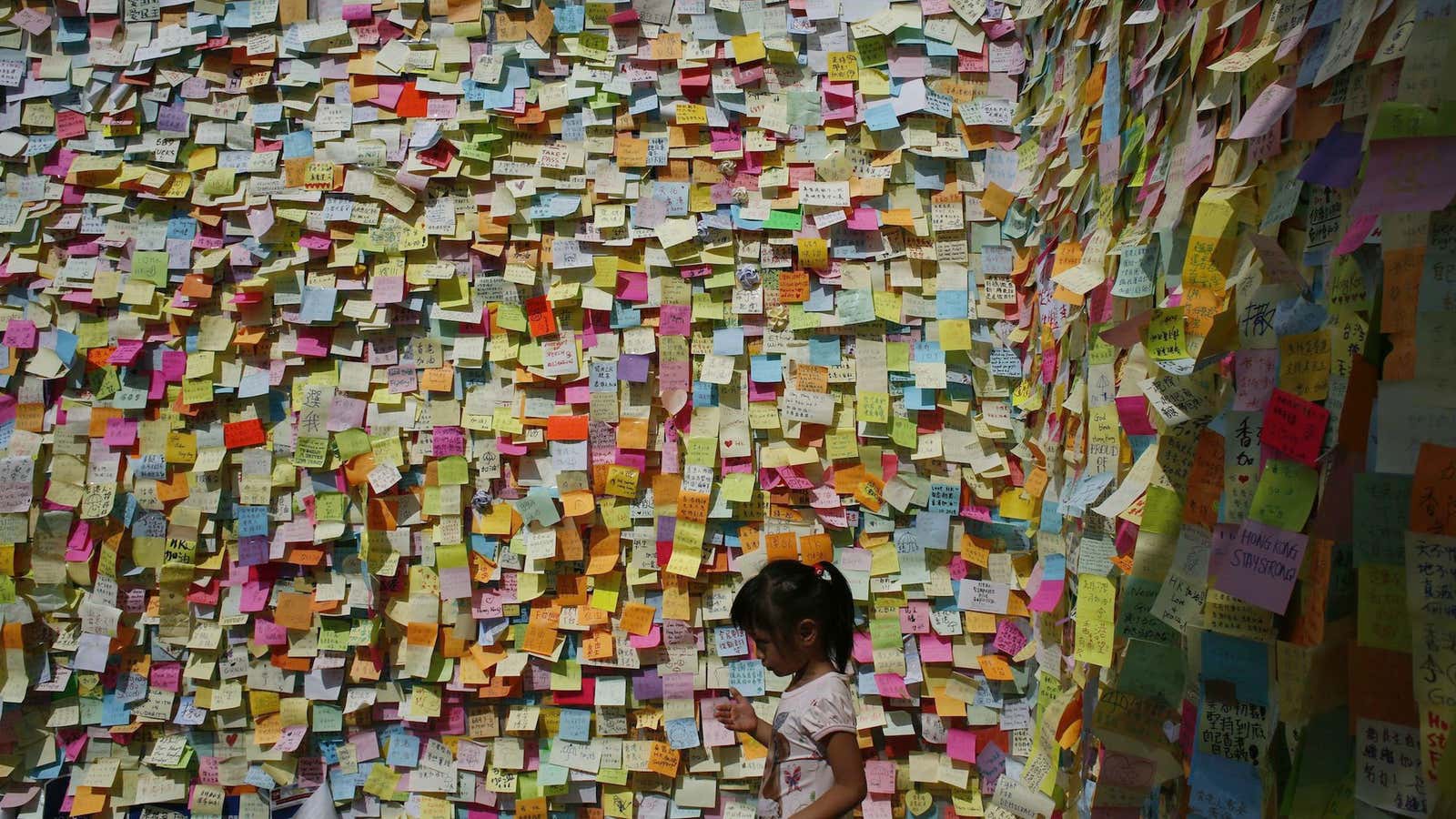 A girl stands at a former protest site in central Hong Kong.