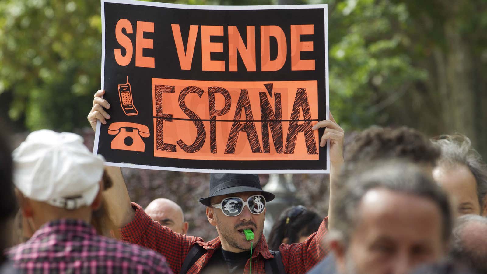 Protestor in Madrid says Spain is for sale.