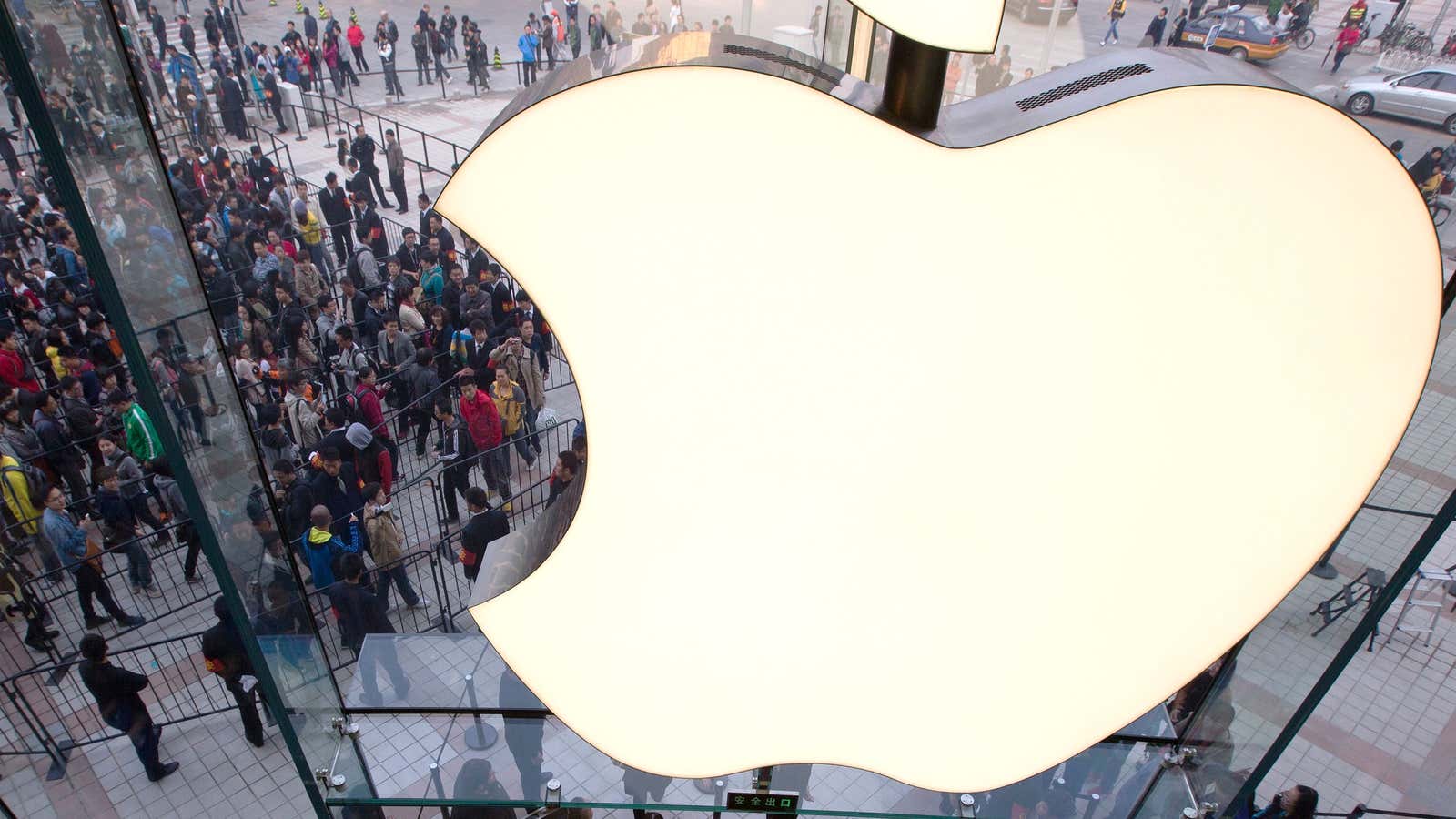 Acolytes prepare for a ritual sacrifice of Renminbi at a newly-opened Apple store in Beijing.