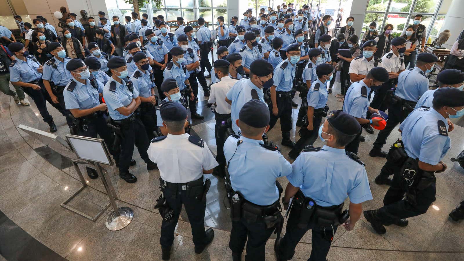 Police officers gather at the headquarters of Apple Daily in Hong Kong, China June 17, 2021.