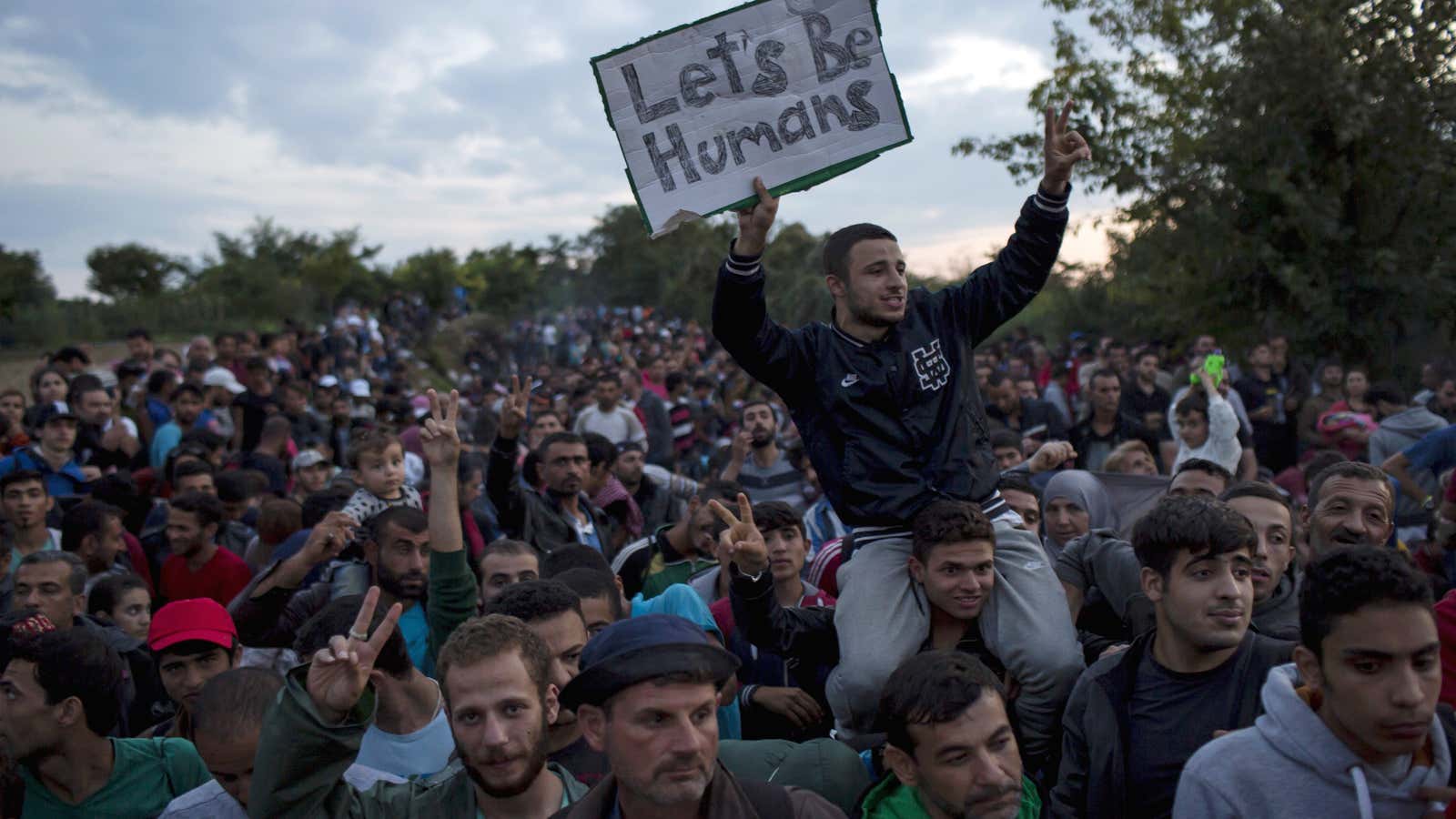 Migrants wait to board buses on a field near the village of Babska, Croatia, in Sep. 2015.