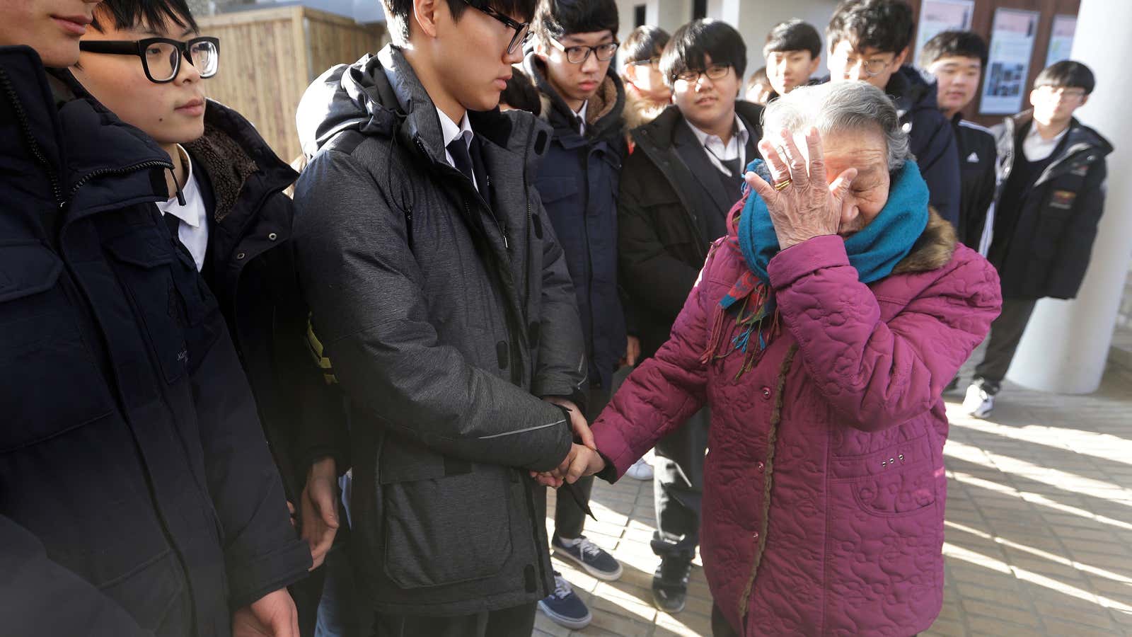 Former South Korean comfort woman Park Ok-seon wipes her tears on Dec. 29, 2015.