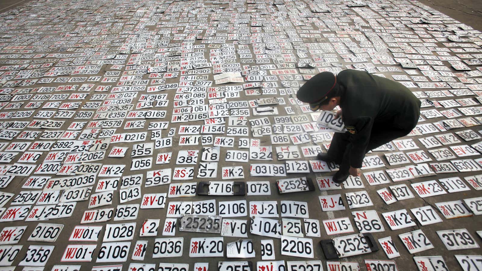 A soldier checks through fake military license plates.