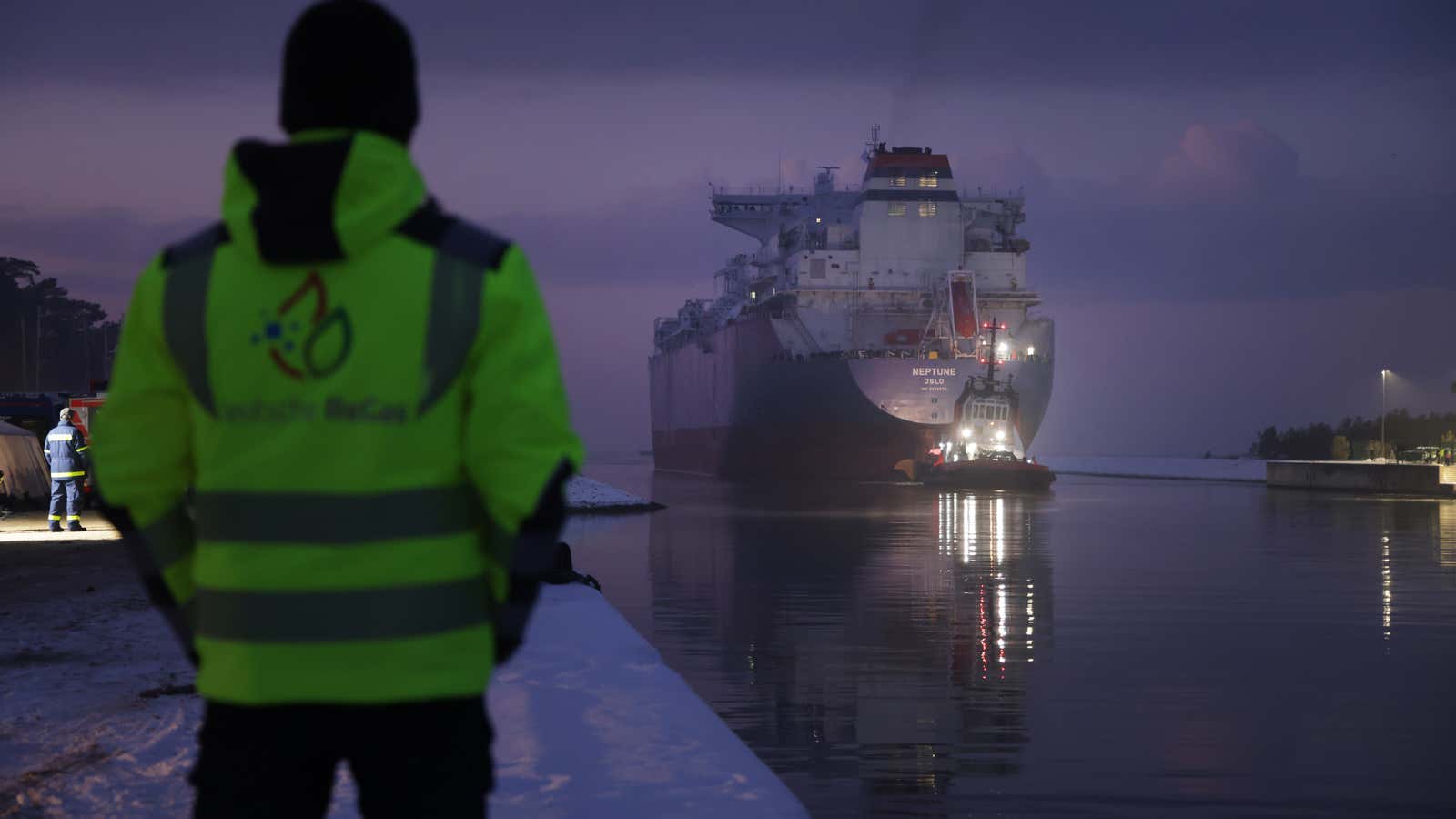 An employee of Deutsche ReGas watches as a tugboat pulls the &quot;Neptune,&quot; a Norwegian-flagged FSRU ship, backwards into Lubmin Port, Germany to a new terminal for importing liquified natural gas (LNG) on December 15, 2022.