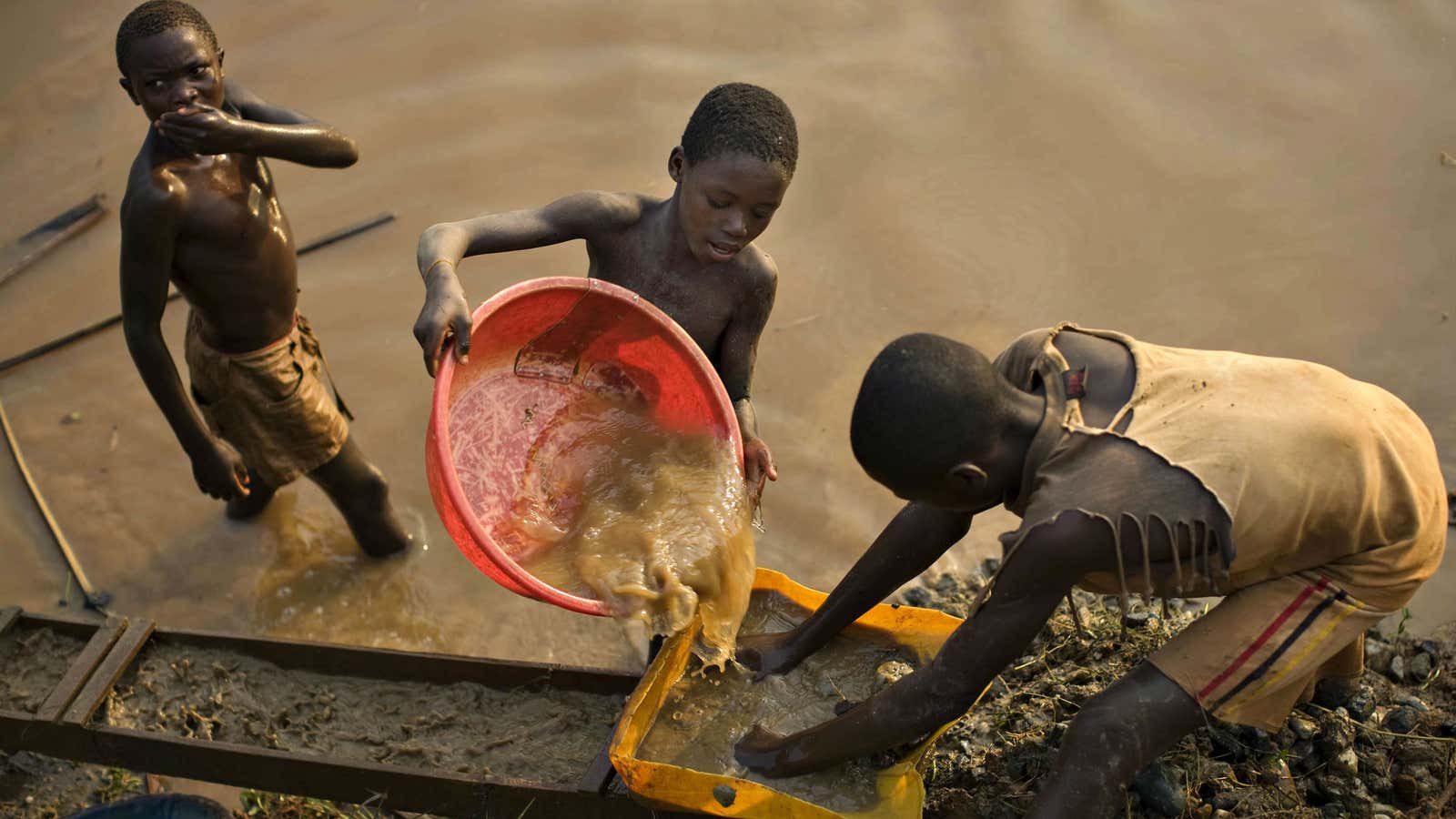 Boys pan for gold in the resource-rich Ituri region of eastern Congo.