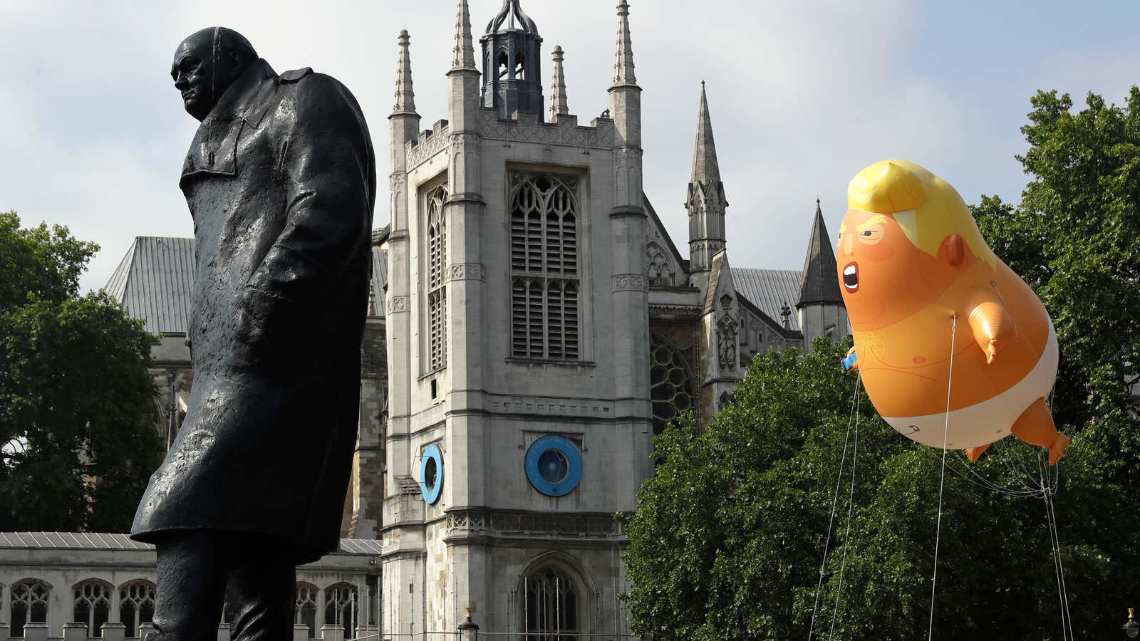 The Trump baby floats behind a statue of British prime minister Winston Churchill.