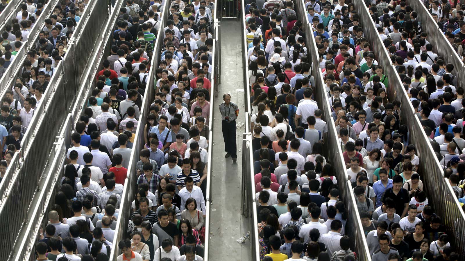 Waiting to go through security during the morning rush hour at Tiantongyuan North Station, Beijing on May 27.