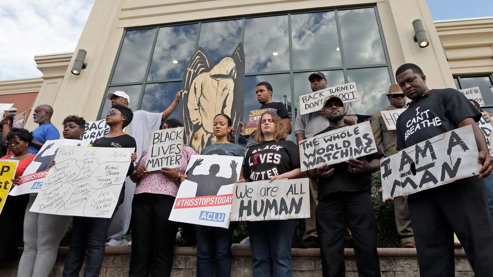 Demonstrators pause for a moment of silence to protest the shooting death of Walter Scott at city hall in North Charleston.