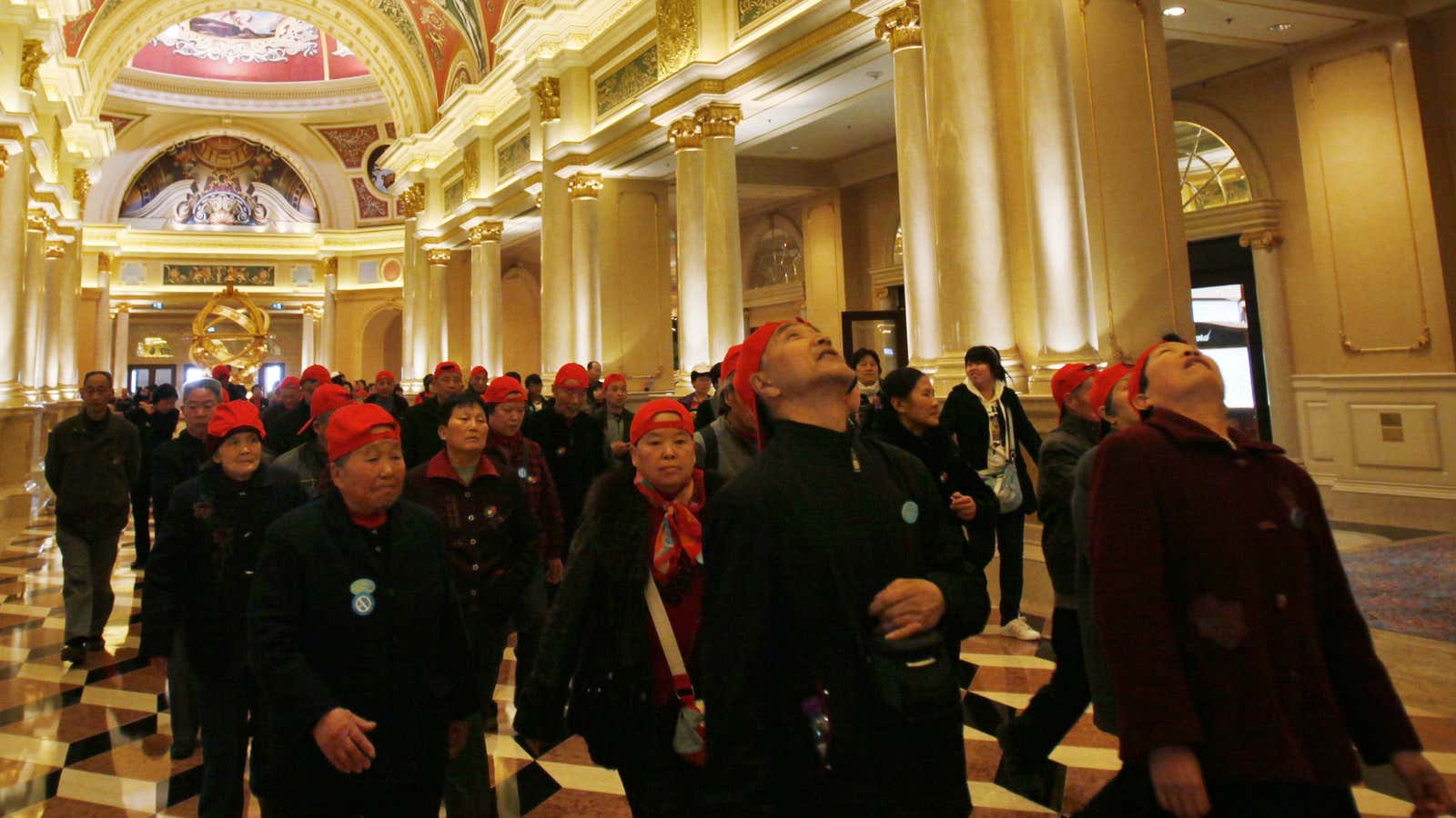 Chinese tourists throng into the Venetian Macau casino, owned by Las Vegas Sands, which has admitted it possibly violated US anti-bribery laws.