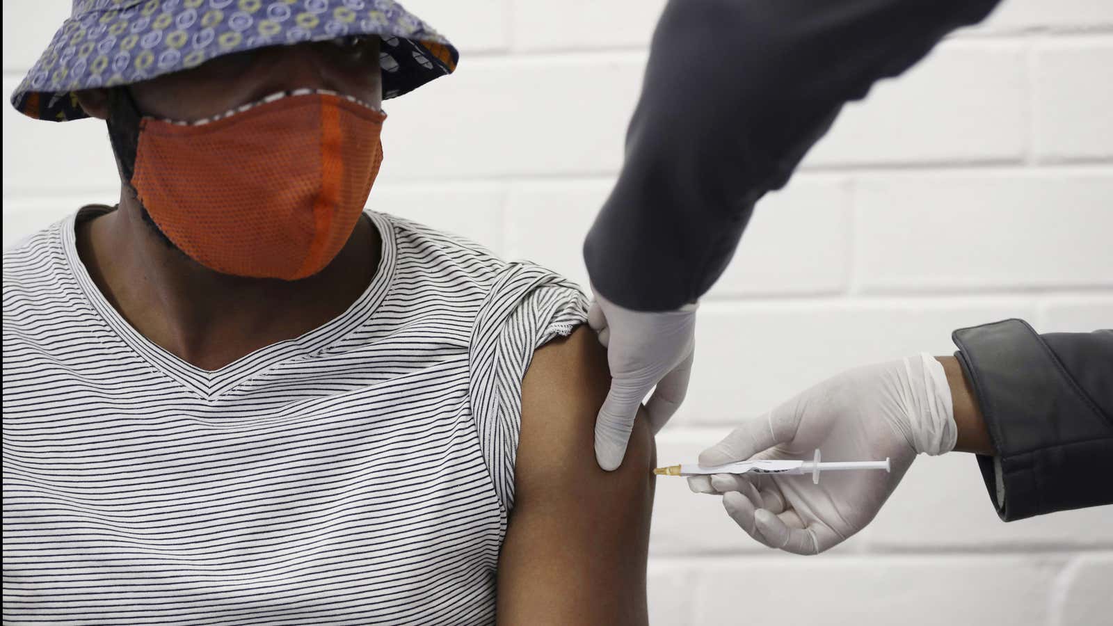 A volunteer receives a Covid-19 test vaccine injection developed at the University of Oxford in Britain in Soweto, Johannesburg