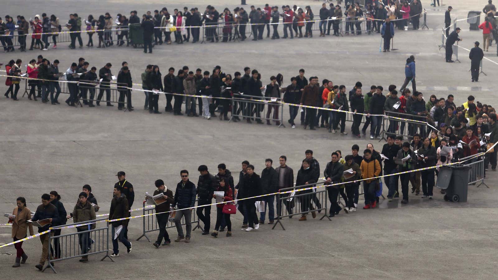 Junior college students line up outside a job fair in Zhengzhou, Henan province