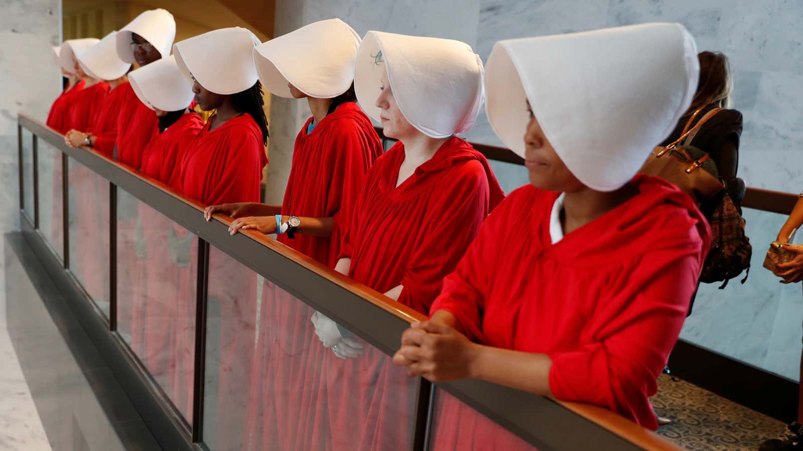 Demonstrators dressed as handmaidens await the arrival of US Supreme Court nominee judge Brett Kavanaugh at Senate Judiciary Committee confirmation hearing.