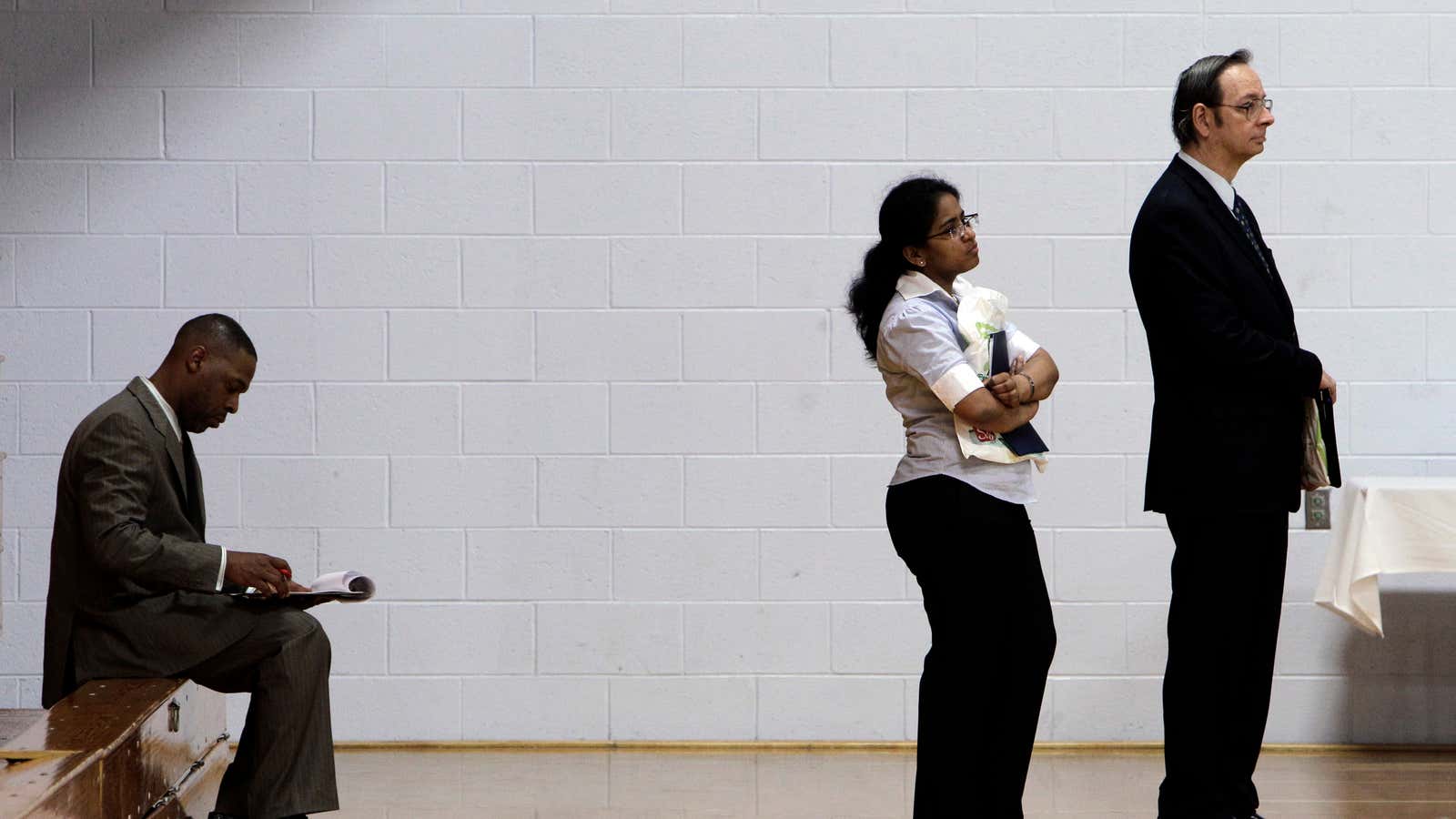 Job seekers wait in a line at a job fair in Southfield, Mich., Wednesday, June 15, 2011. Fewer Americans applied for unemployment benefits last week,…