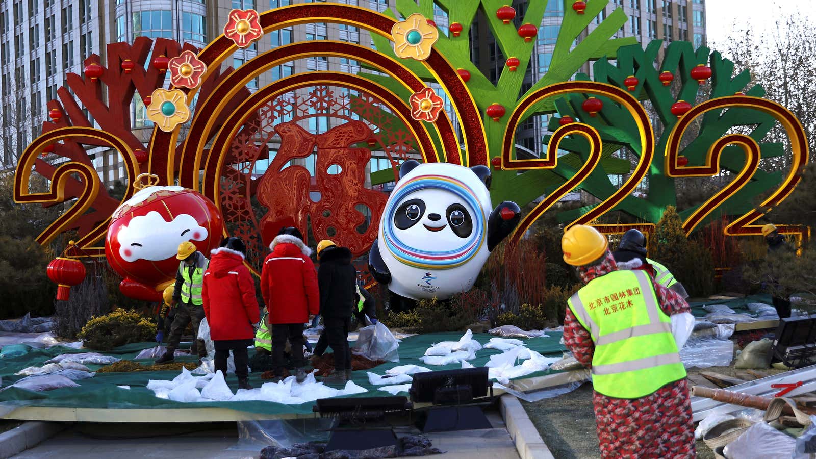 Workers build an installation featuring mascots of the Beijing 2022 Winter Olympics, in Beijing, China January 17, 2022. REUTERS/Tingshu Wang