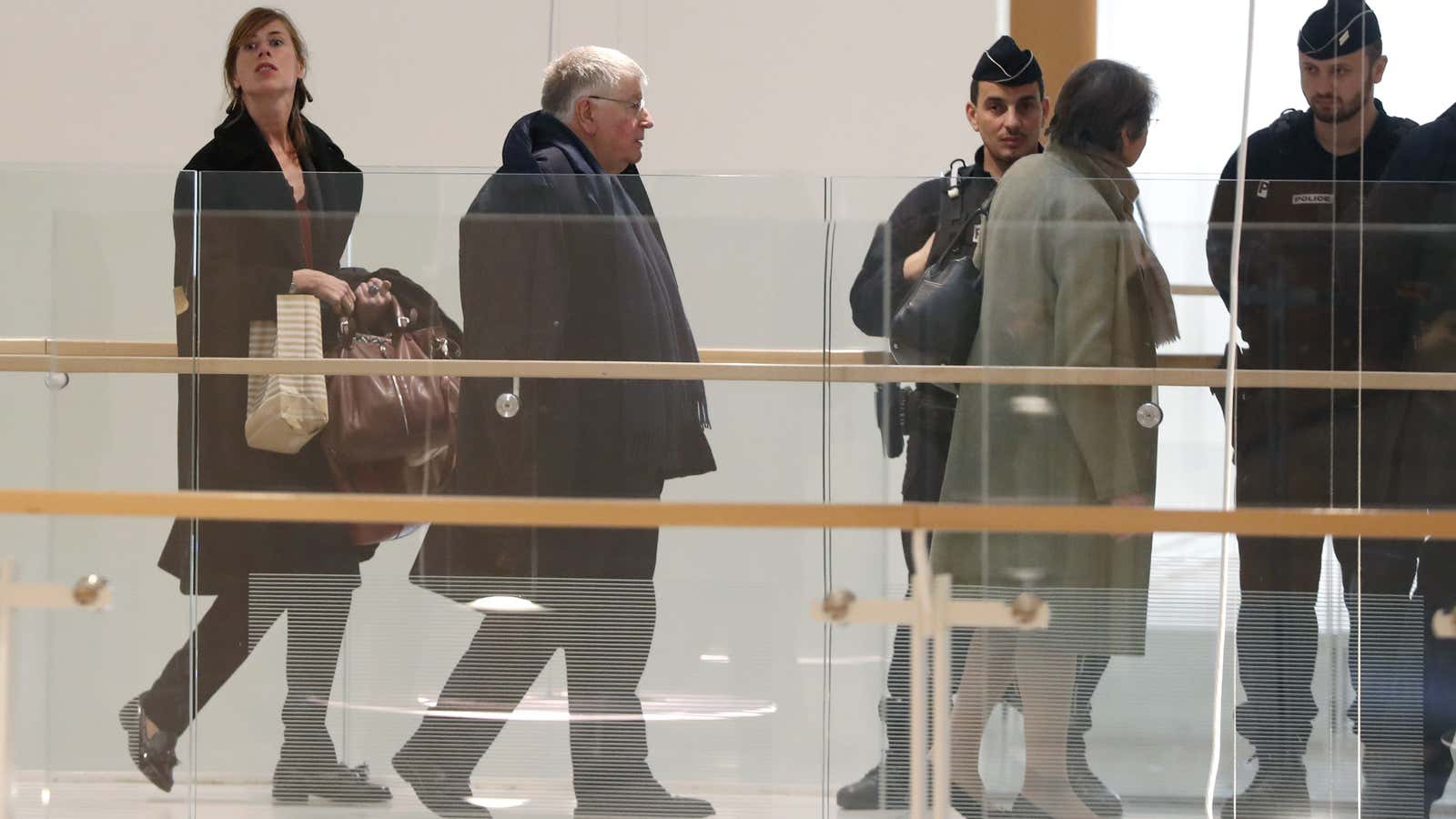 Former CEO Didier Lombard, second from left, arrives for trial.