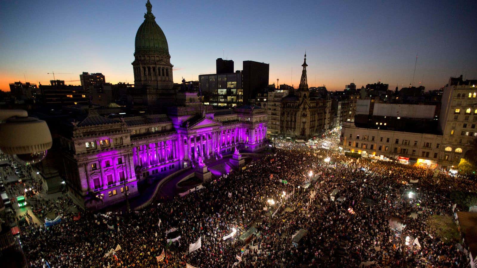 People demonstrate against gender violence outside the National Congress .