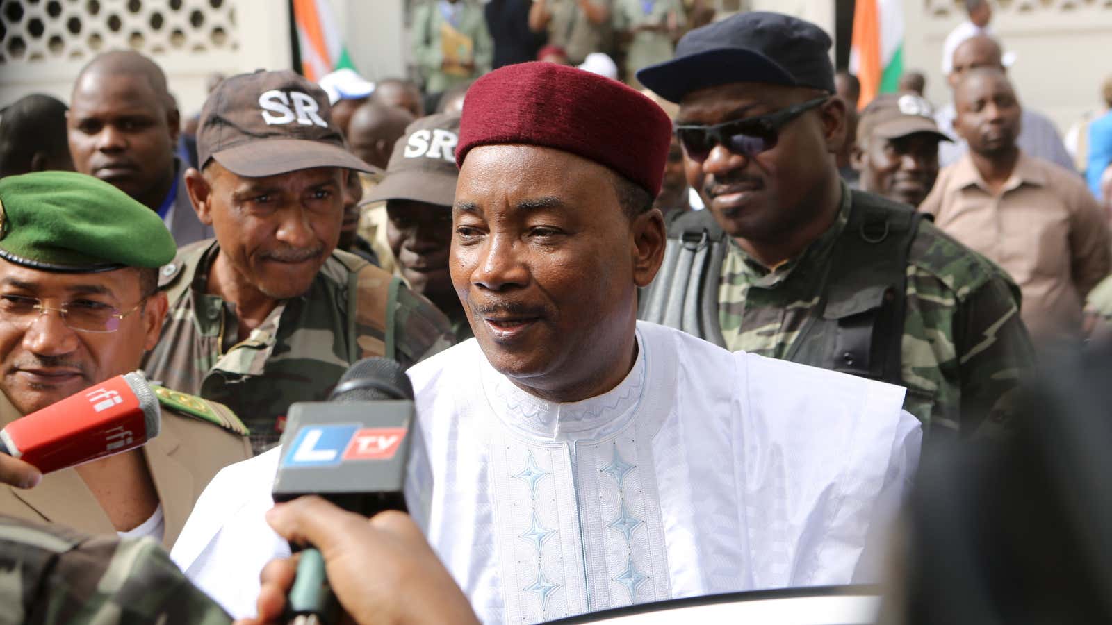 Niger’s incumbent President Mahamadou Issoufou speaks to journalists after voting.